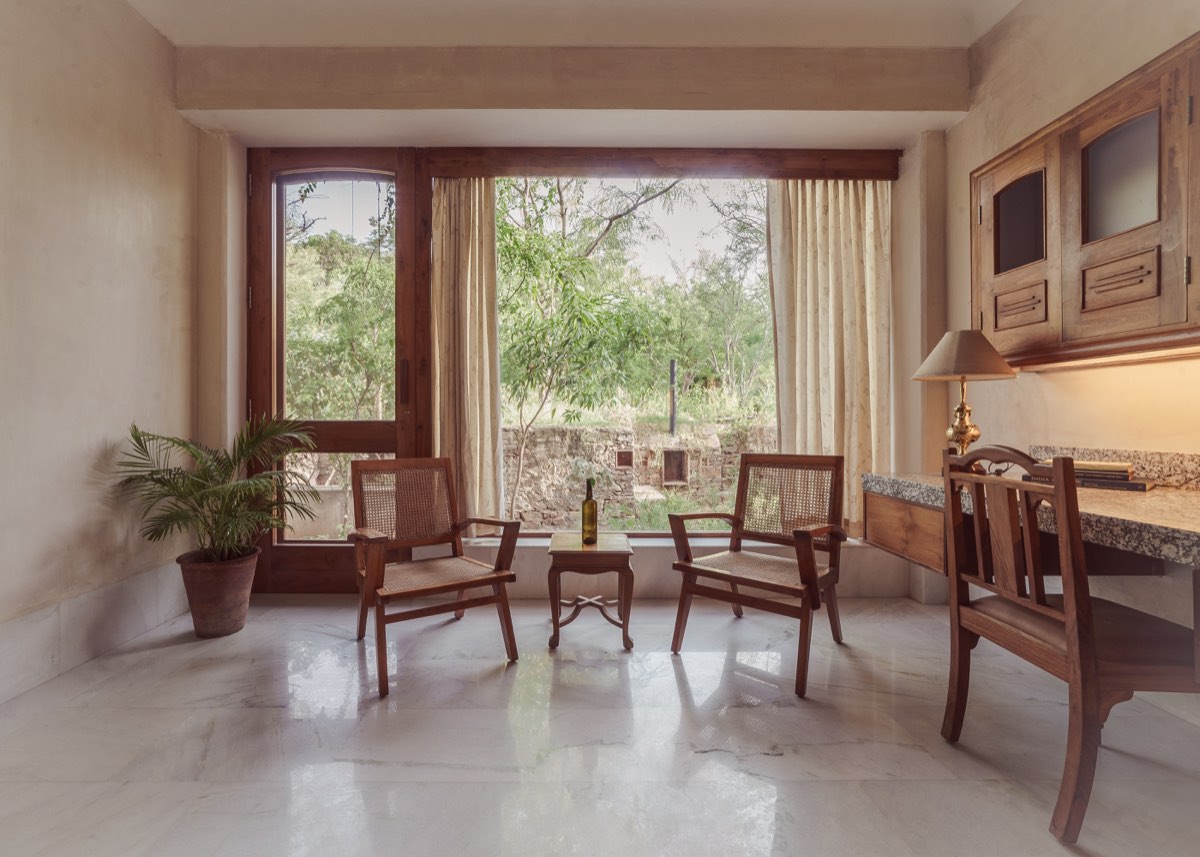 The Suite work area — cane chairs, desk, and the garden window